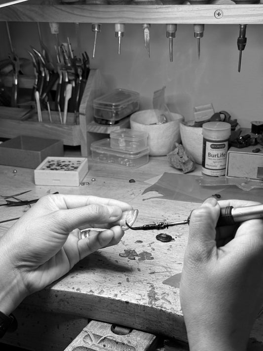 Lia making wax on her bench.