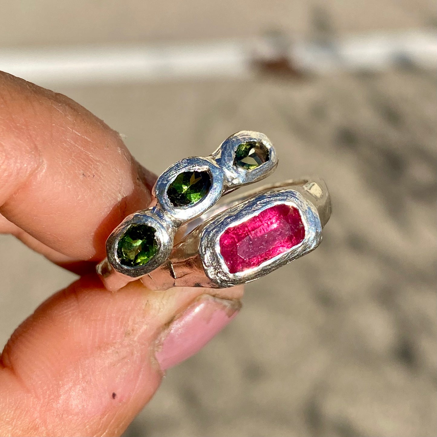 Handmade by Lia from Lia Makes Jewellery, this sterling silver ring stack features green and pink tourmalines. Sold as a set of two, available in size O 1/2 (US 7 1/4).