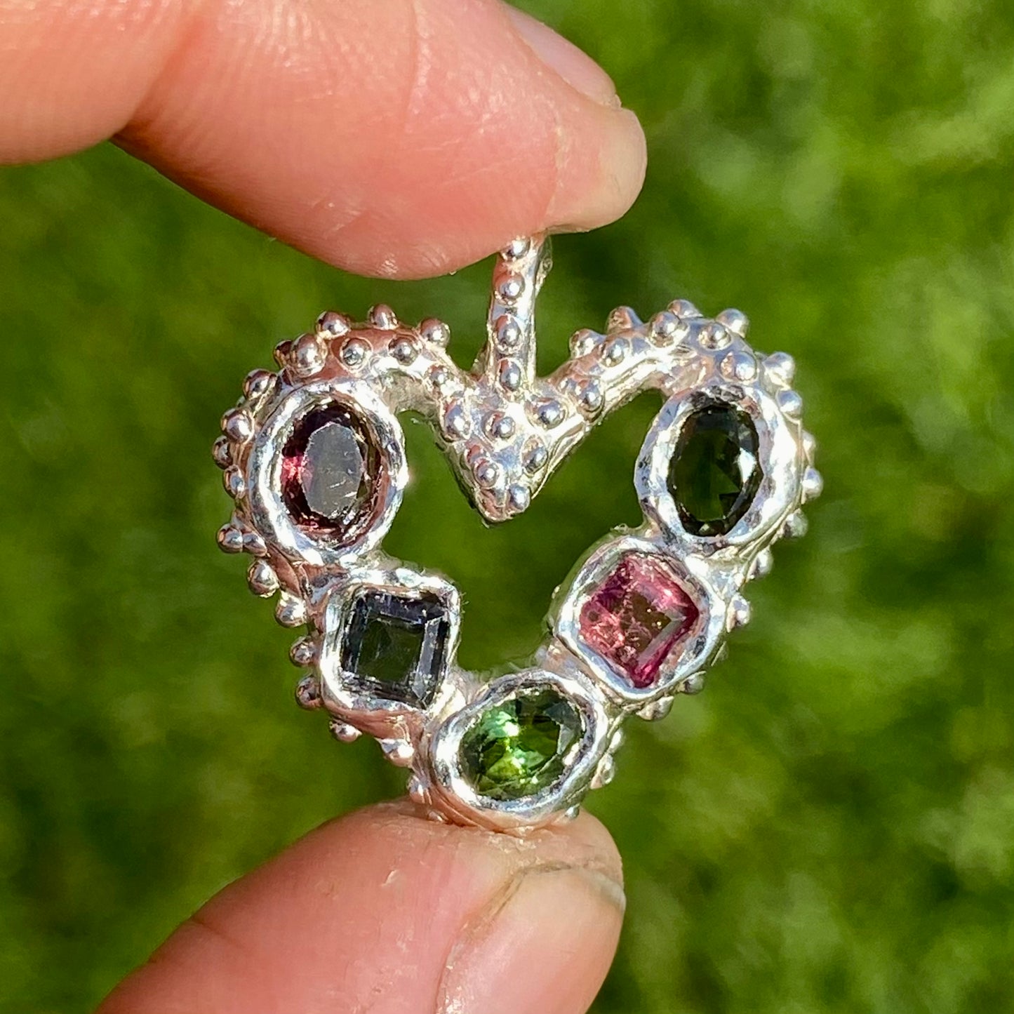 Dancing Heart Pendants are a collection of two unique, handmade pendants featuring vibrant tourmaline gemstones. Each pendant showcases five sparkling stones, playfully accented with tiny beads. Choose your favourite! They come with a delicate 42cm chain included.
