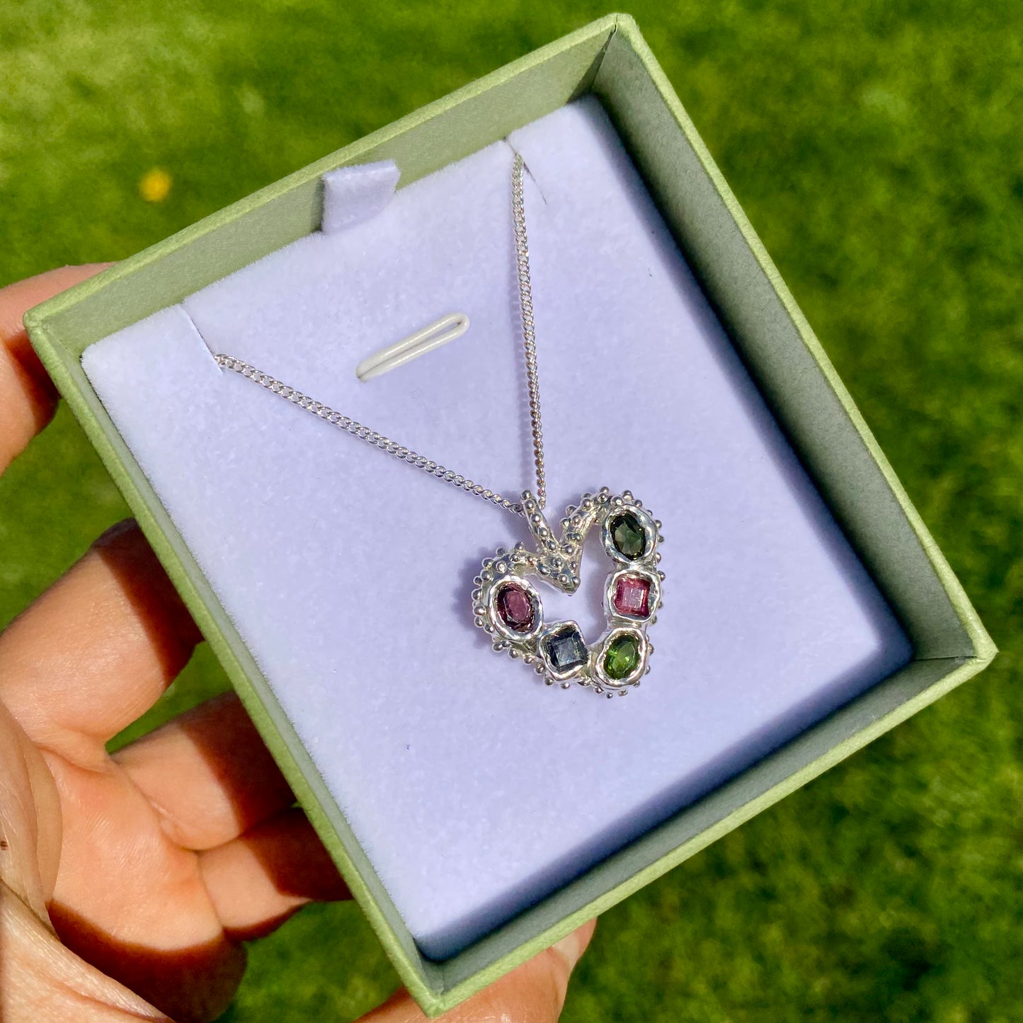 Dancing Heart Pendants are a collection of two unique, handmade pendants featuring vibrant tourmaline gemstones. Each pendant showcases five sparkling stones, playfully accented with tiny beads. Choose your favourite! They come with a delicate 42cm chain included.