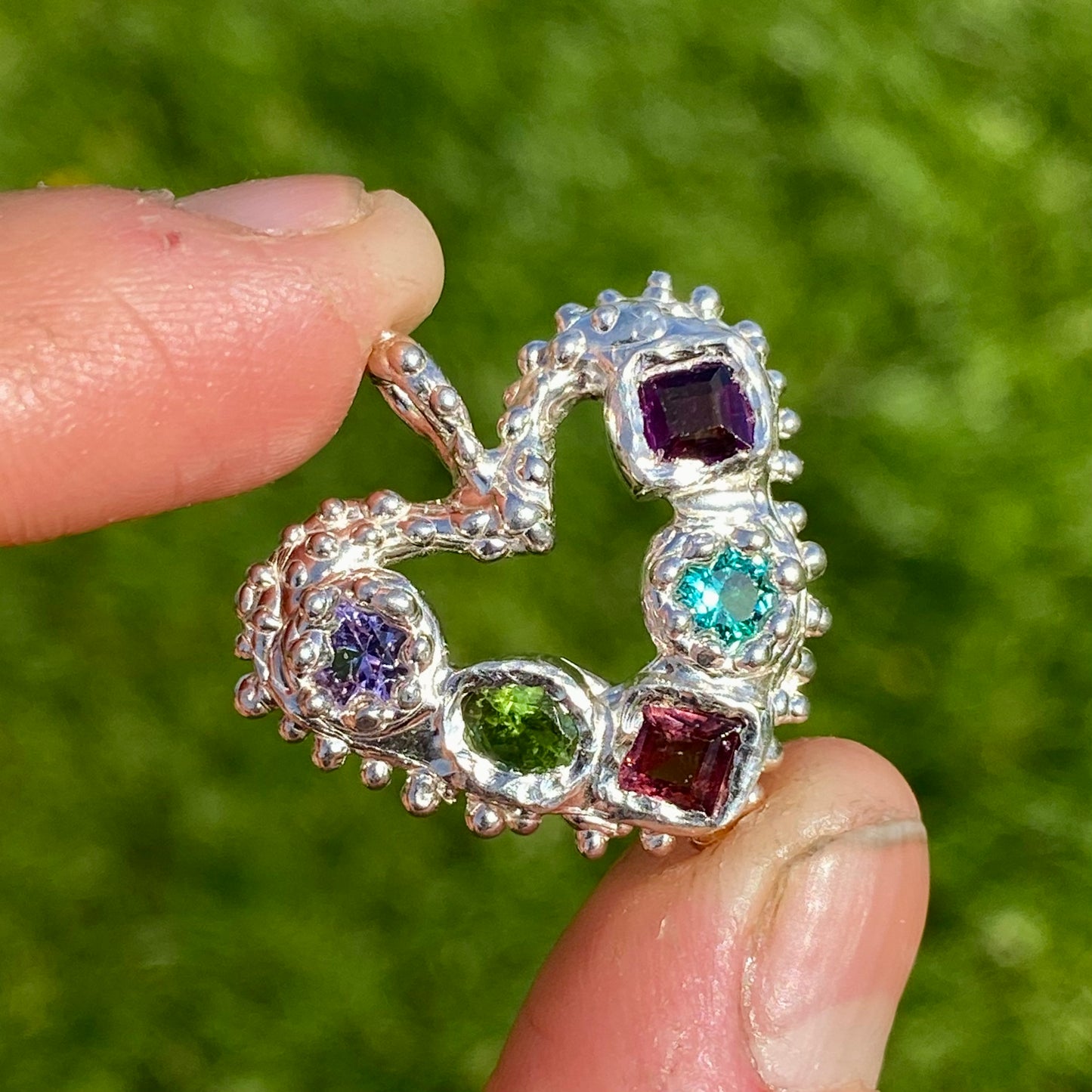 Dancing Heart Pendants are a collection of two unique, handmade pendants featuring vibrant tourmaline gemstones. Each pendant showcases five sparkling stones, playfully accented with tiny beads. Choose your favourite! They come with a delicate 42cm chain included.