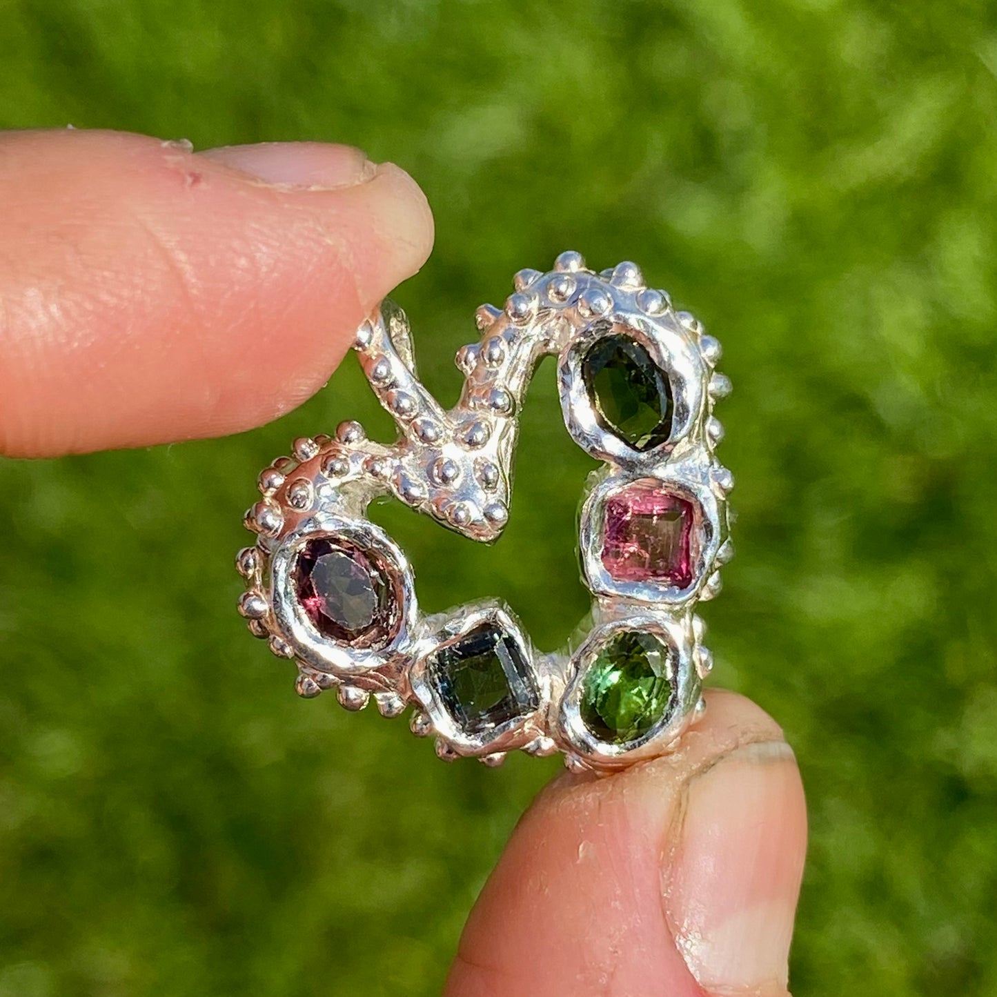 Dancing Heart Pendants are a collection of two unique, handmade pendants featuring vibrant tourmaline gemstones. Each pendant showcases five sparkling stones, playfully accented with tiny beads. Choose your favourite! They come with a delicate 42cm chain included.