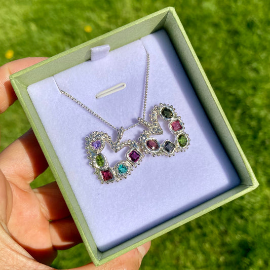 Dancing Heart Pendants are a collection of two unique, handmade pendants featuring vibrant tourmaline gemstones. Each pendant showcases five sparkling stones, playfully accented with tiny beads. Choose your favourite! They come with a delicate 42cm chain included.