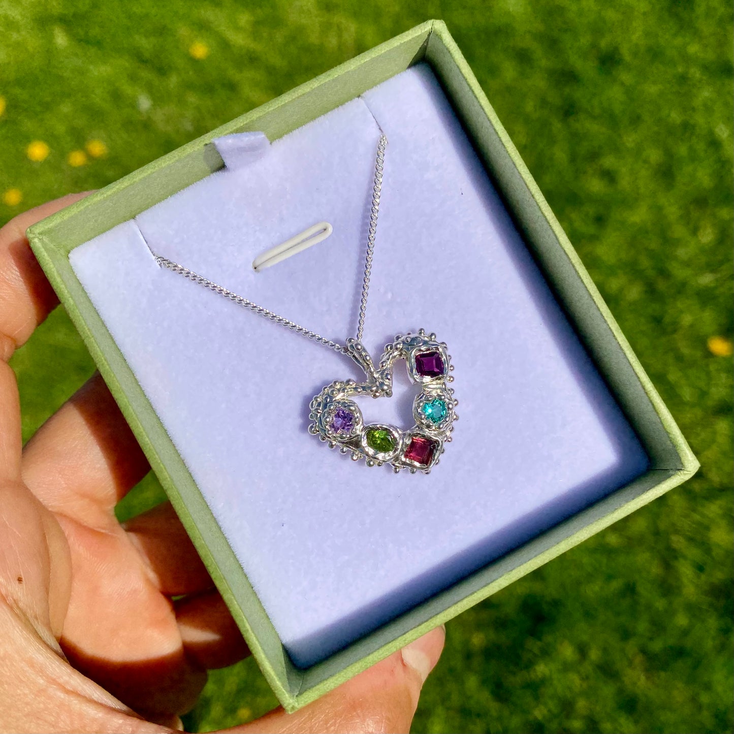 Dancing Heart Pendants are a collection of two unique, handmade pendants featuring vibrant tourmaline gemstones. Each pendant showcases five sparkling stones, playfully accented with tiny beads. Choose your favourite! They come with a delicate 42cm chain included.