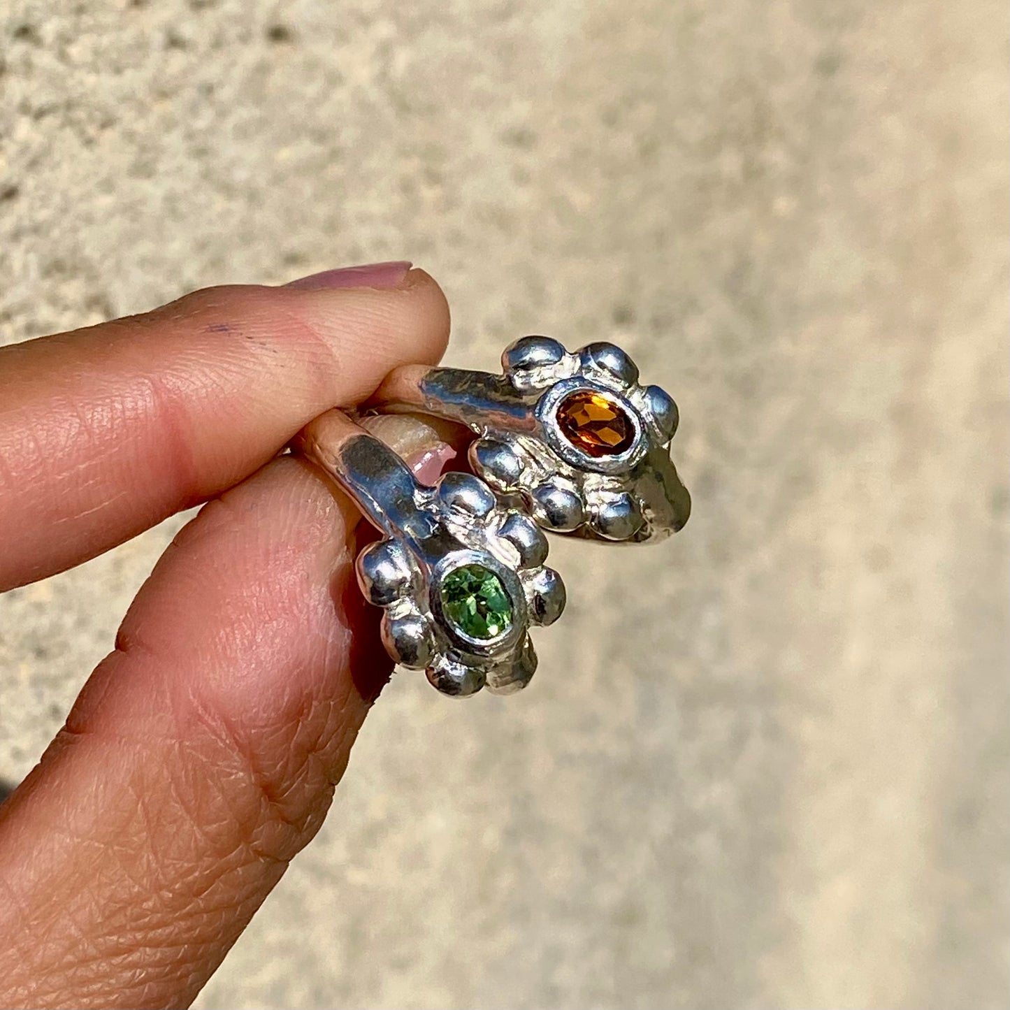 Fleur Ring — meaning flower in French — is a sterling silver ring featuring a vibrant tourmaline stone, available in green, pink, yellow, and light blue. This updated version of the Fleur Ring comes with a thicker band for a bolder look.