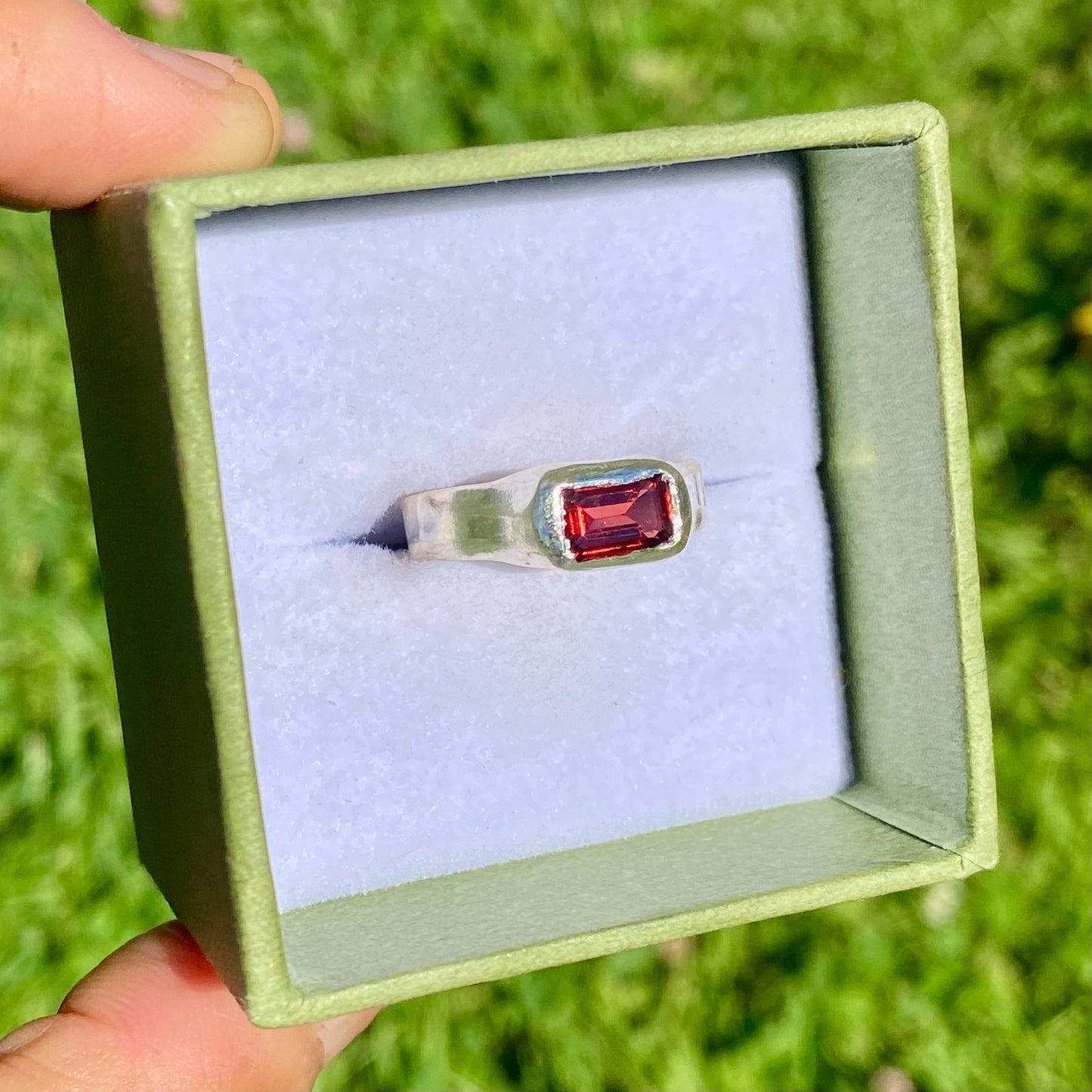 Garnet Pinky Ring features a rich red garnet stone set on a delicate band. Handmade by me in sterling silver, this ring is available in size M (US 6).