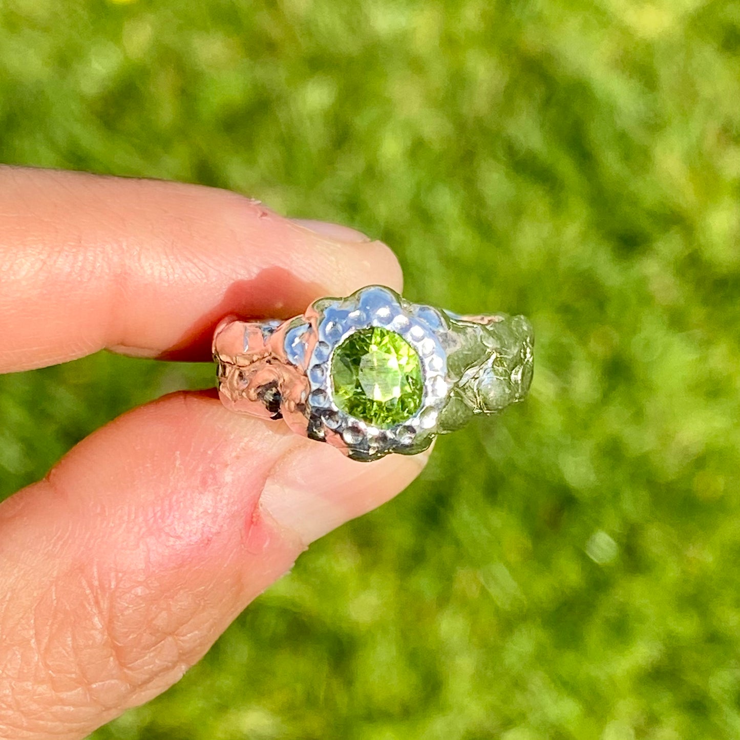 Embrace springtime with the Hallo Green Ring! This chunky sterling silver ring features a vibrant green peridot stone. Available in size O (US 7) with resizing services. Shop unique, handmade jewellery by Lia Makes Jewellery!