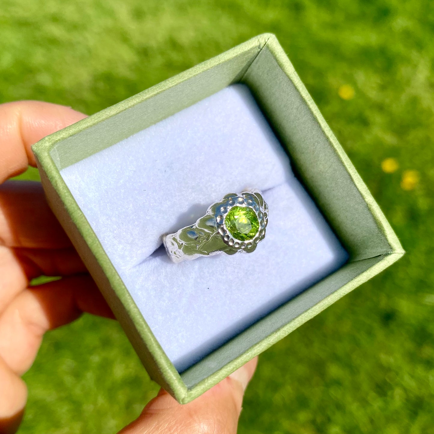 Embrace springtime with the Hallo Green Ring! This chunky sterling silver ring features a vibrant green peridot stone. Available in size O (US 7) with resizing services. Shop unique, handmade jewellery by Lia Makes Jewellery!
