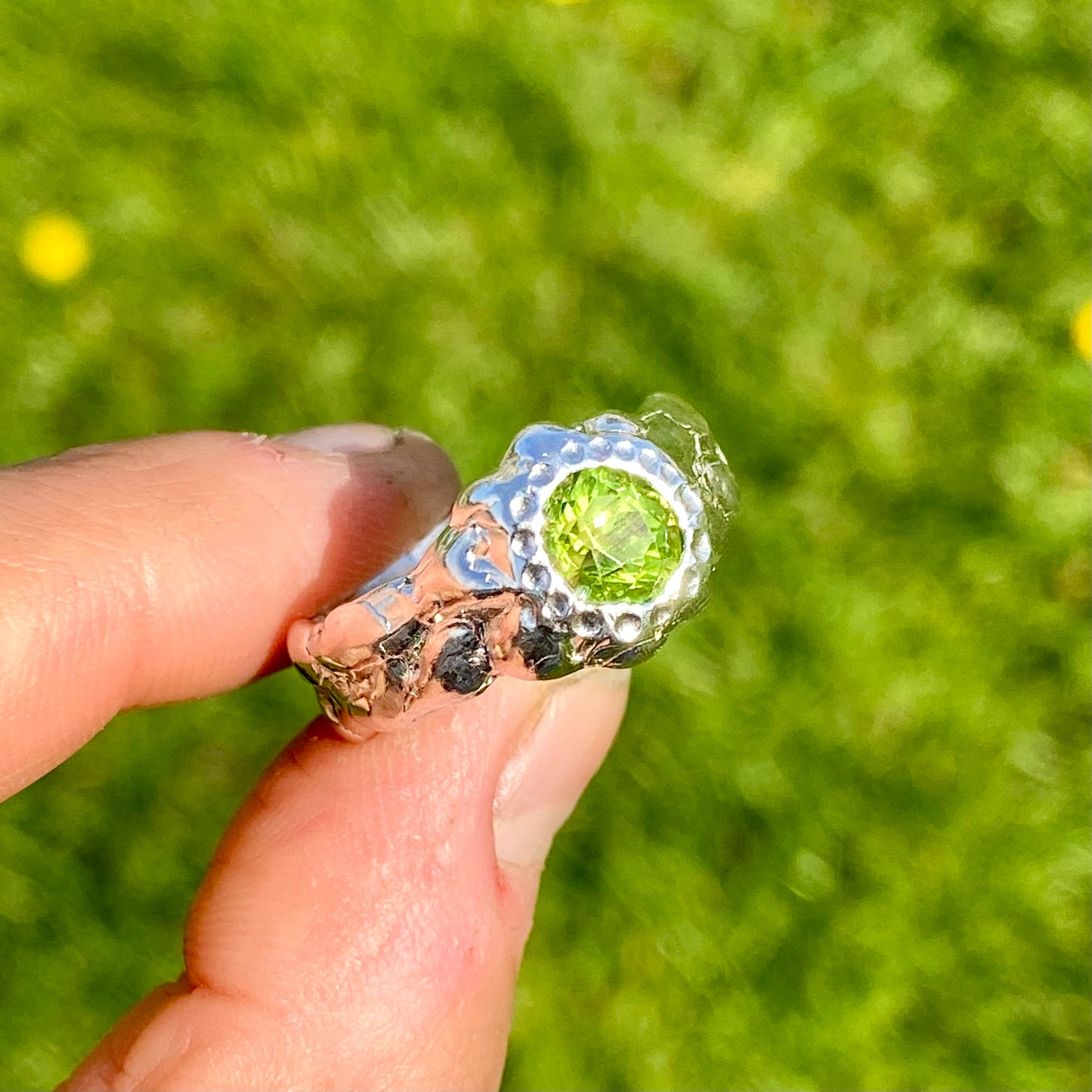 Embrace springtime with the Hallo Green Ring! This chunky sterling silver ring features a vibrant green peridot stone. Available in size O (US 7) with resizing services. Shop unique, handmade jewellery by Lia Makes Jewellery!