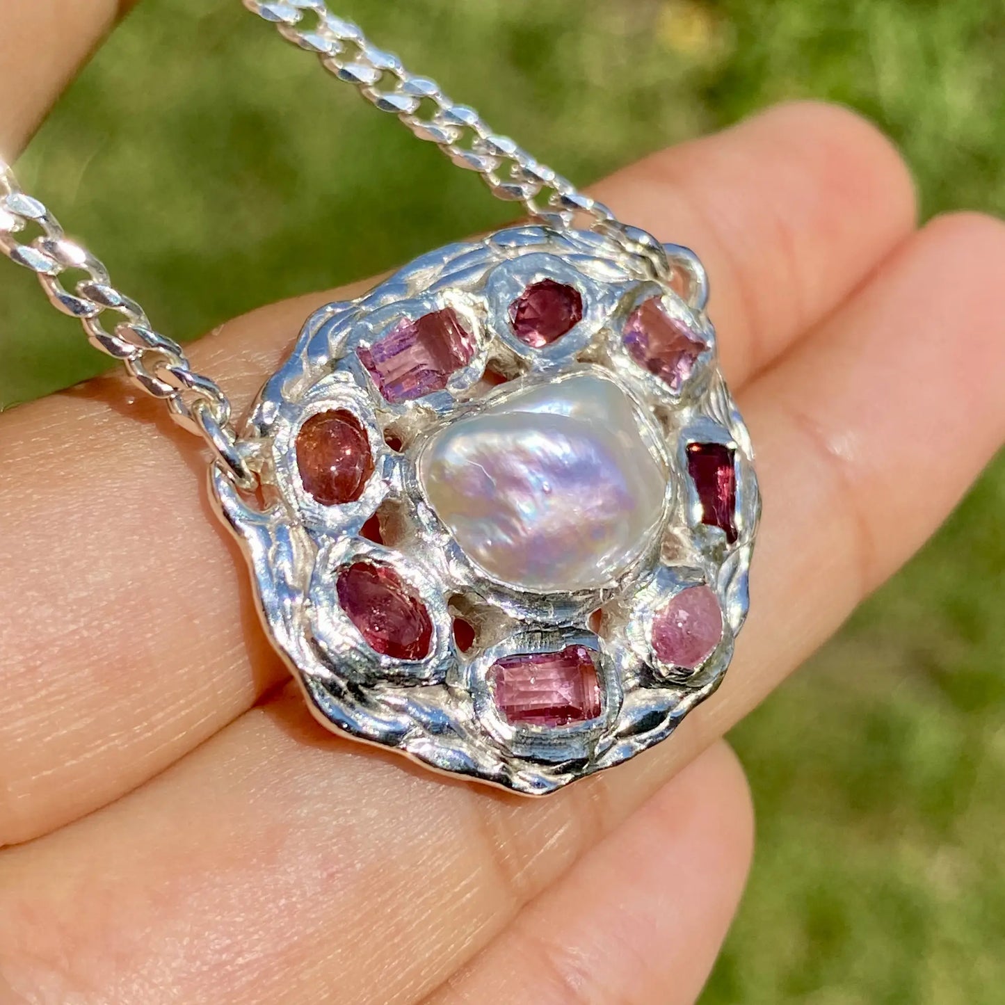 Inner bloom pendant on hand