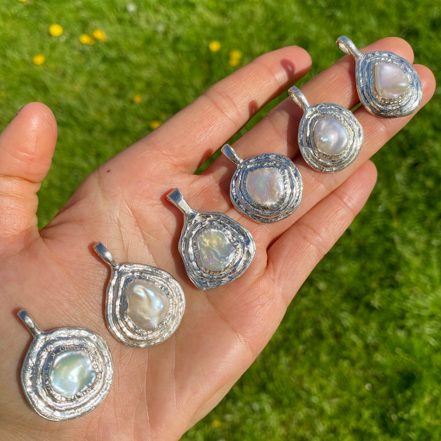 All the six mime pendants in one hand. Handmade by Lia in sterling silver.