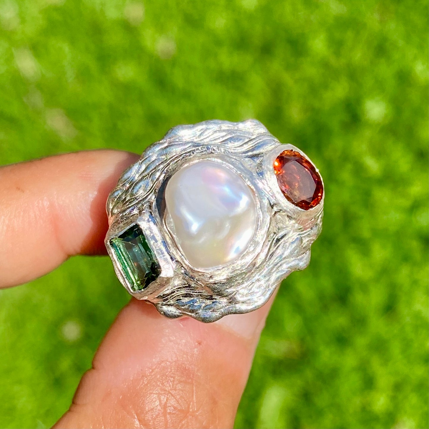 The Ocean Flame features a thick band with three stones: Keshi pearl, green rectangle tourmaline, and orange citrine stone. Handmade by me from sterling silver, this ring is available in size O 1/2 (US 7 1/4).