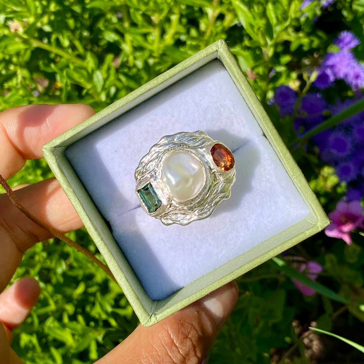 The Ocean Flame features a thick band with three stones: Keshi pearl, green rectangle tourmaline, and orange citrine stone. Handmade by me from sterling silver, this ring is available in size O 1/2 (US 7 1/4).