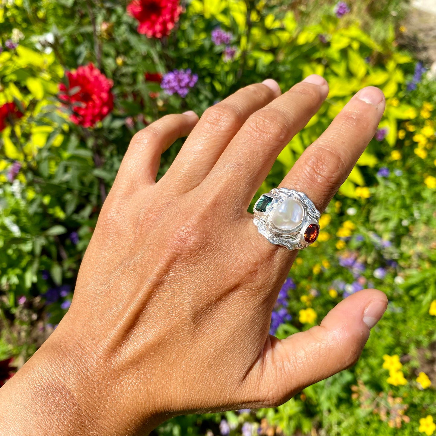 The Ocean Flame features a thick band with three stones: Keshi pearl, green rectangle tourmaline, and orange citrine stone. Handmade by me from sterling silver, this ring is available in size O 1/2 (US 7 1/4).