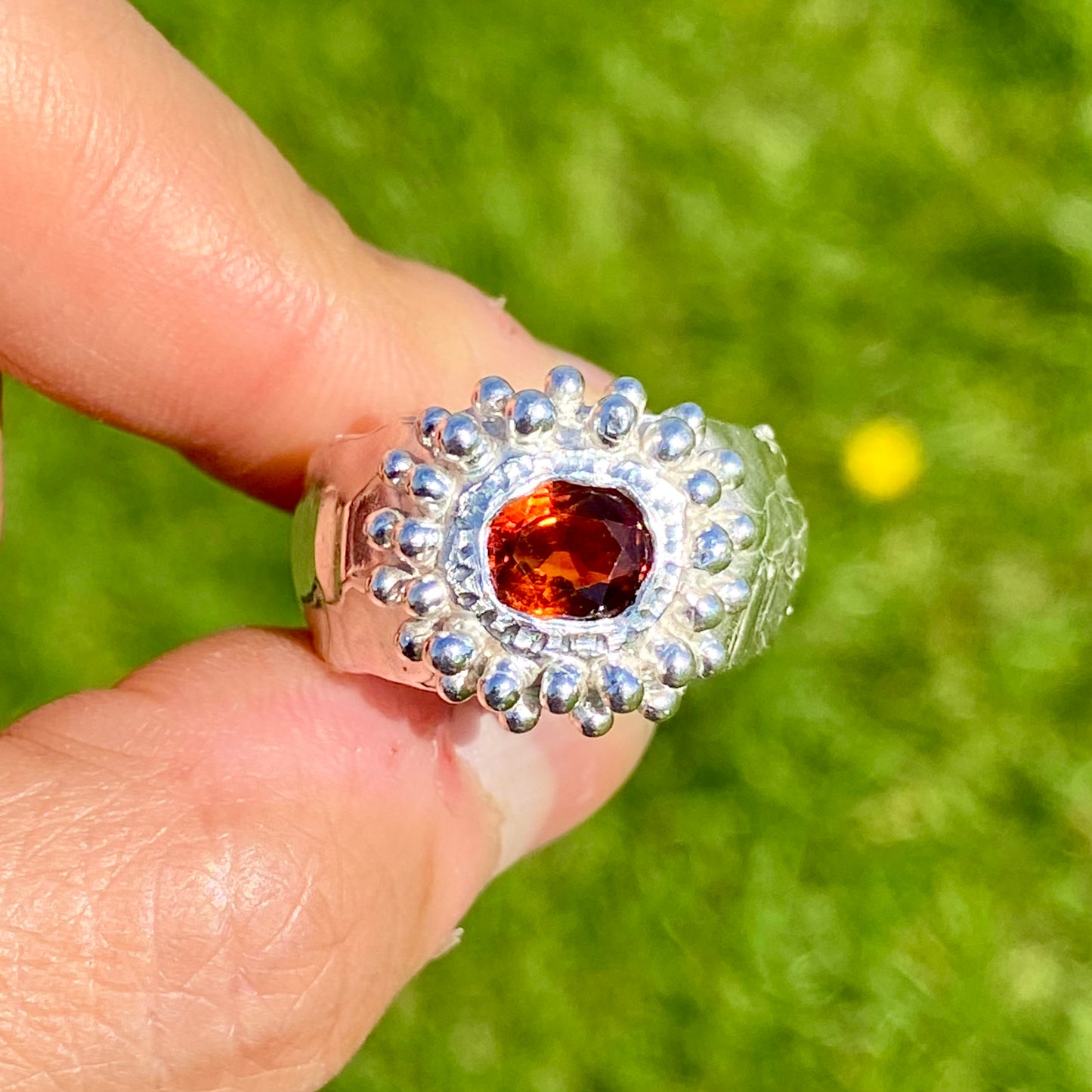Orange Whisper Ring features an orange citrine in a wide chunky band. Handmade from sterling silver, this ring comes in a single size: M 1/2 or 6 1/4.