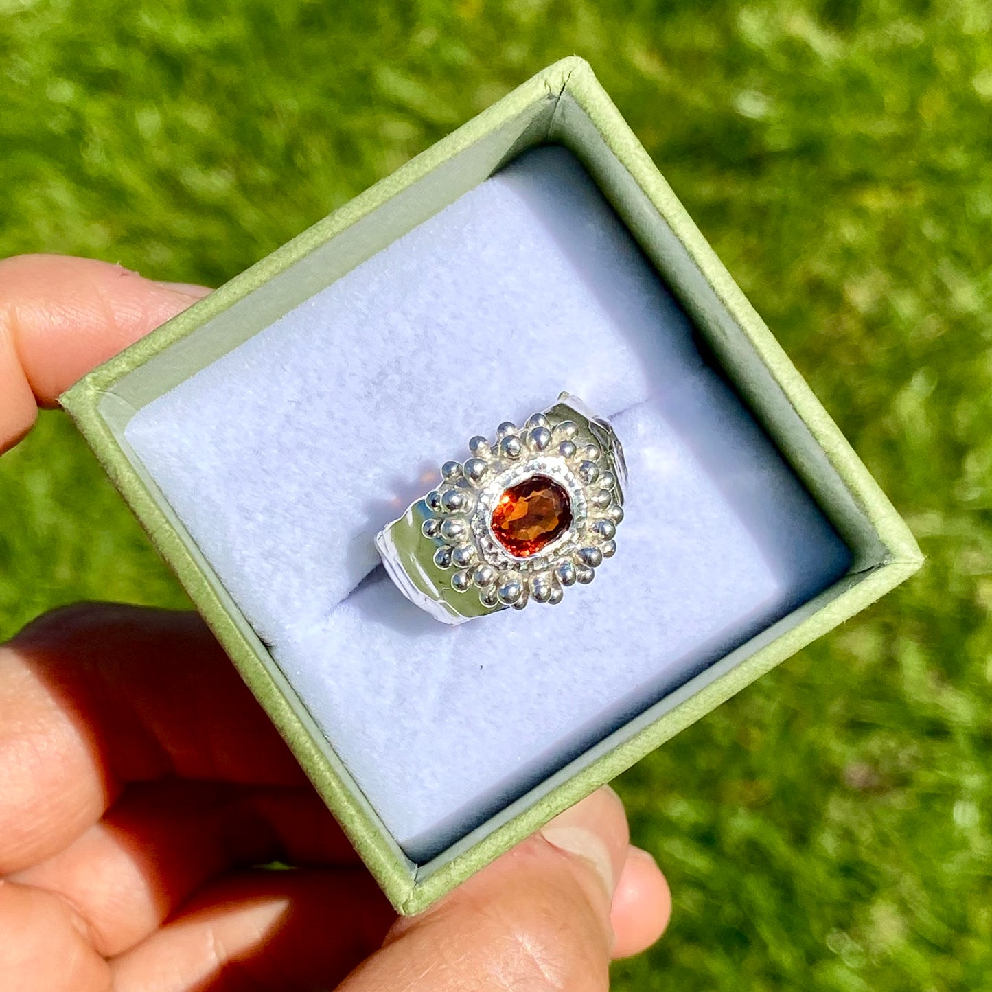 Orange Whisper Ring features an orange citrine in a wide chunky band. Handmade from sterling silver, this ring comes in a single size: M 1/2 or 6 1/4.