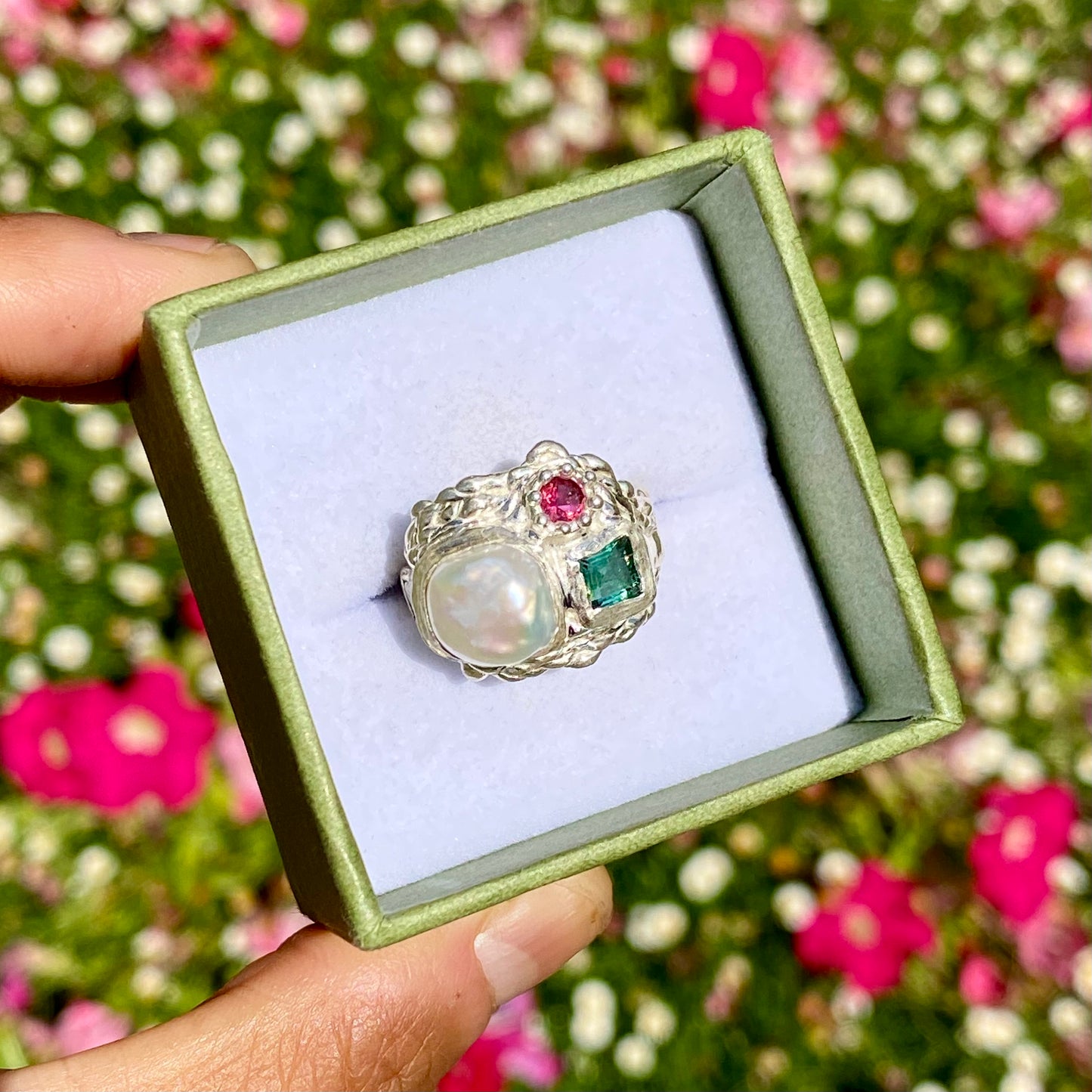 The Pearl Grove features a thick band with three stones: Keshi pearl, green square tourmaline, and pink round stone. Handmade by me from sterling silver, this ring is available in size O (US 7)