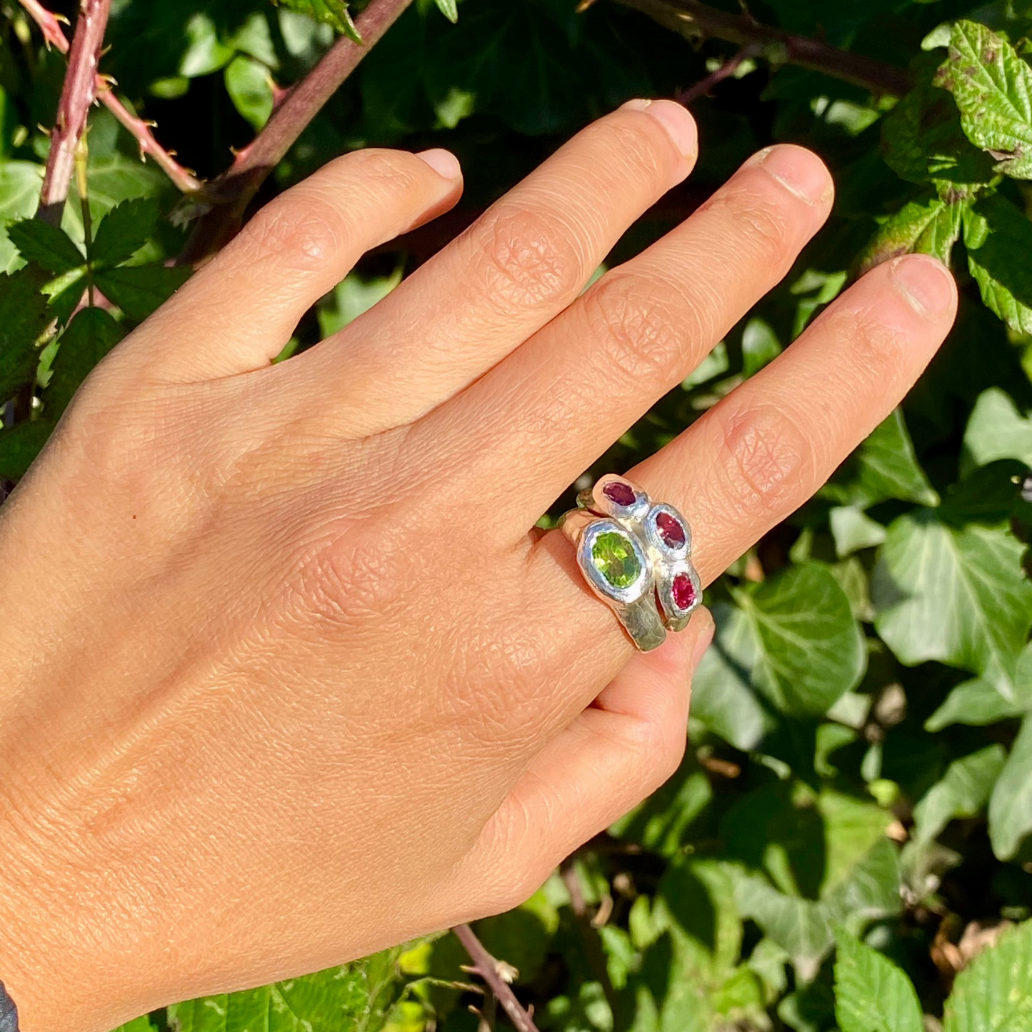 Pink Oasis Ring Stack comes as a set of two stacking rings. One ring features three pink tourmaline stones, while the other holds a green peridot. Handmade by me in sterling silver, these rings are available in size P (US 7 1/2).
