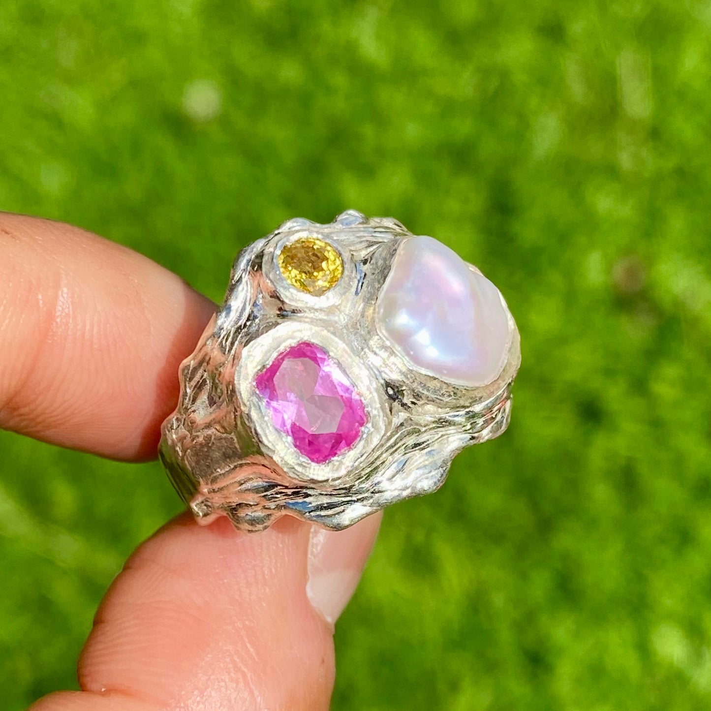 Spring Petals features a thick band with three stones: Keshi pearl, pink topaz, and yellow sapphire. The ring is available in size N 1/2 (US 6 3/4).