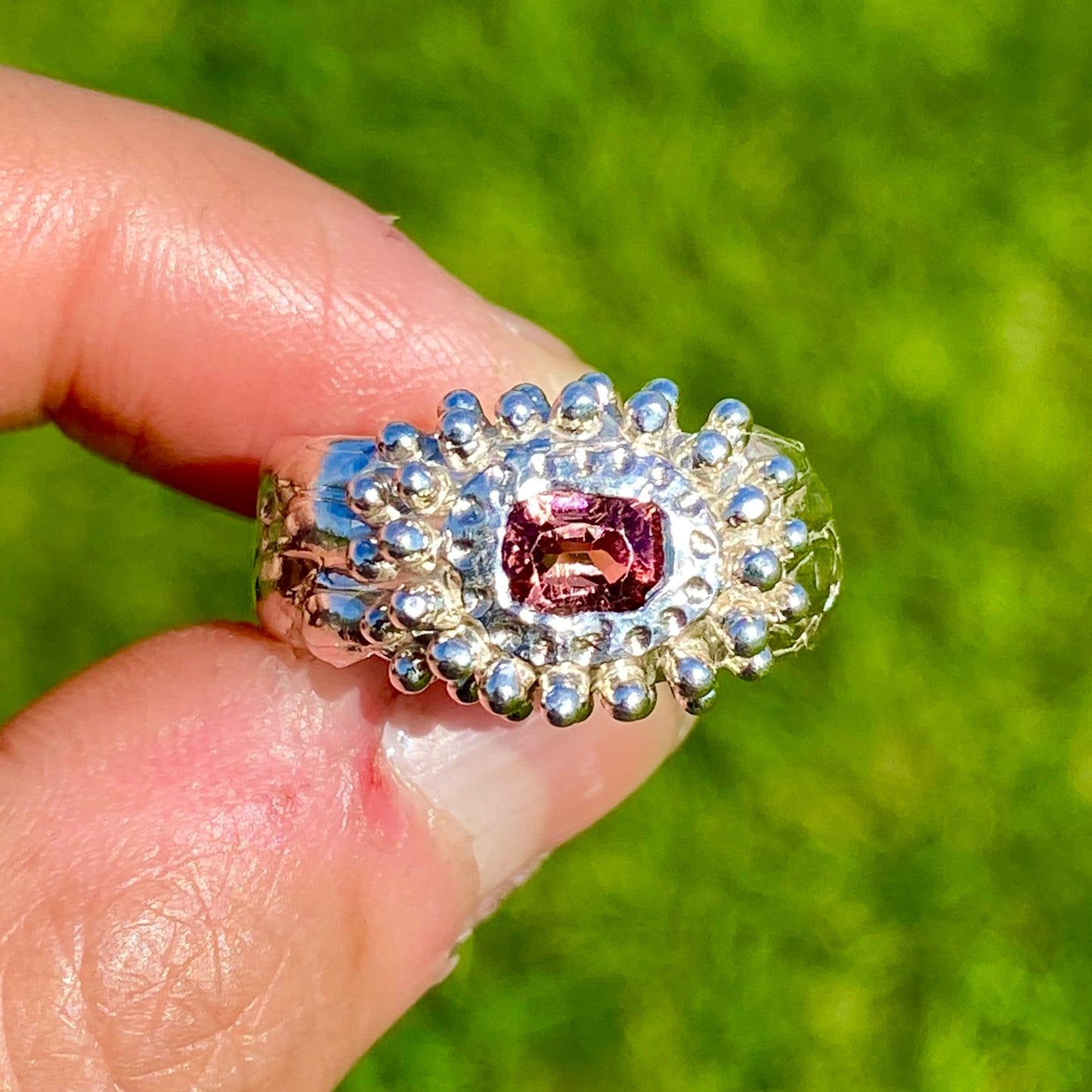Embrace springtime with the Whisper Bloom Ring! This chunky sterling silver ring features a delicate pink spinel gemstone. Available in size US 6 ¼ (with resizing services).