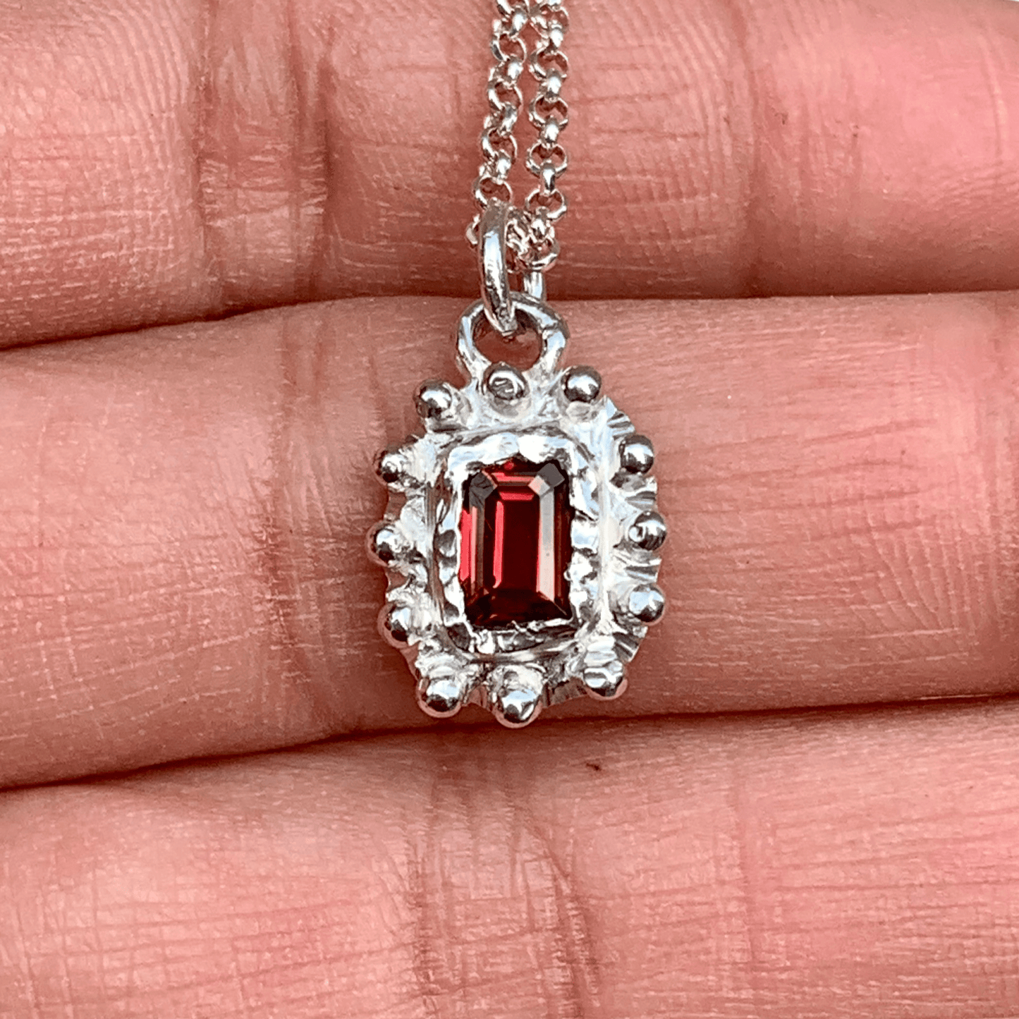 Sterling silver Bola Bola Pendant with red and green tourmalines, 42 cm chain. Shown in my hand. Handmade by Lia in Paris.