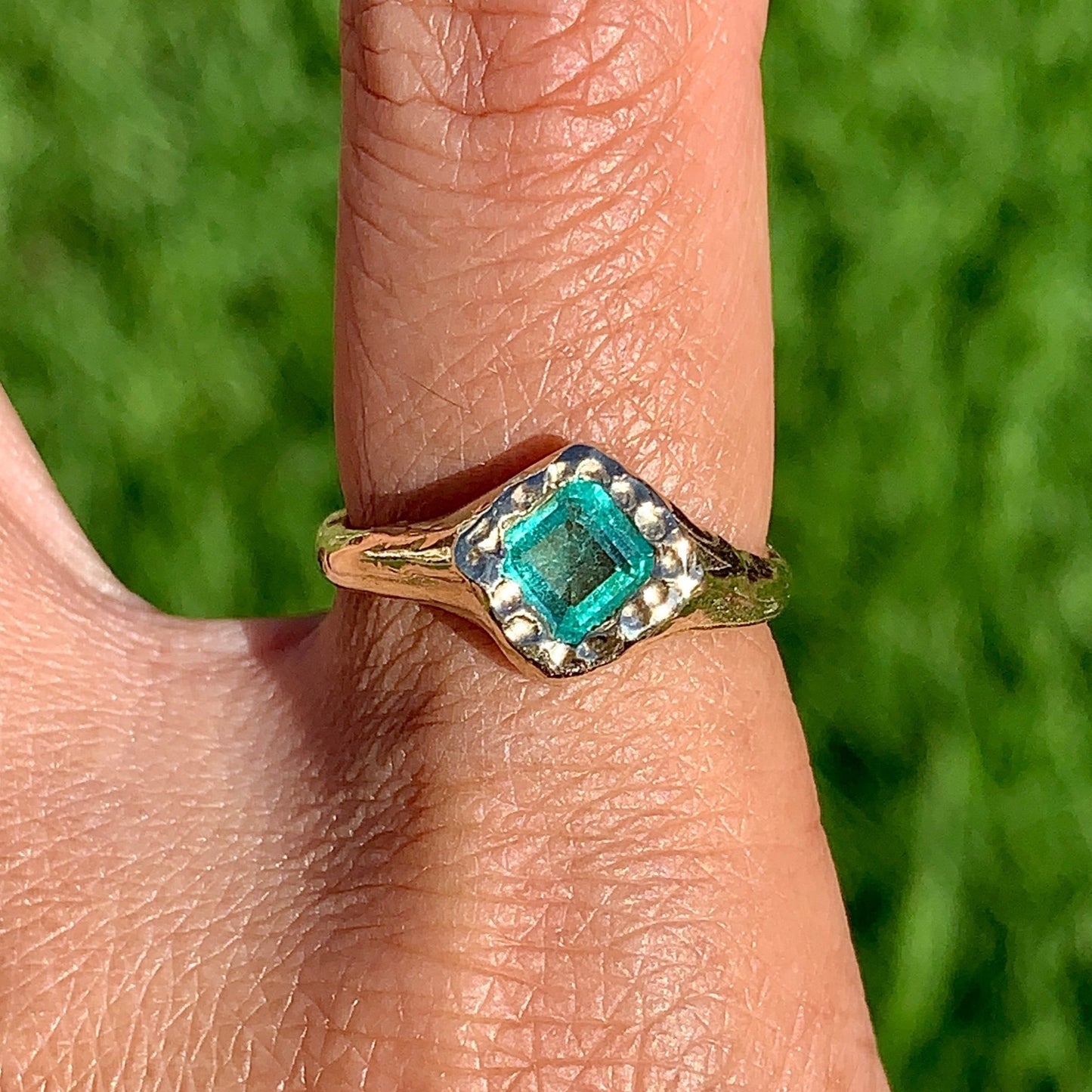 Bring a pop of colour to your jewellery collection with the Square Emerald Ring. This handcrafted piece features a stunning natural emerald stone in 9 carat yellow gold. This ring comes in size P or 7 1/2.