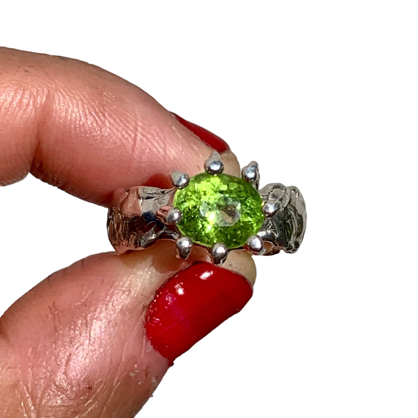 Jungle Queen ring is handmade from sterling silver and features a beautiful green peridot stone securely held in place by silver claws to showcase its captivating colour. It is available in size K 1/2.