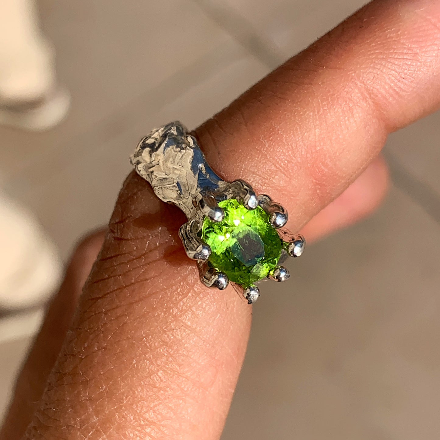Jungle Queen ring is handmade from sterling silver and features a beautiful green peridot stone securely held in place by silver claws to showcase its captivating colour. It is available in size K 1/2.