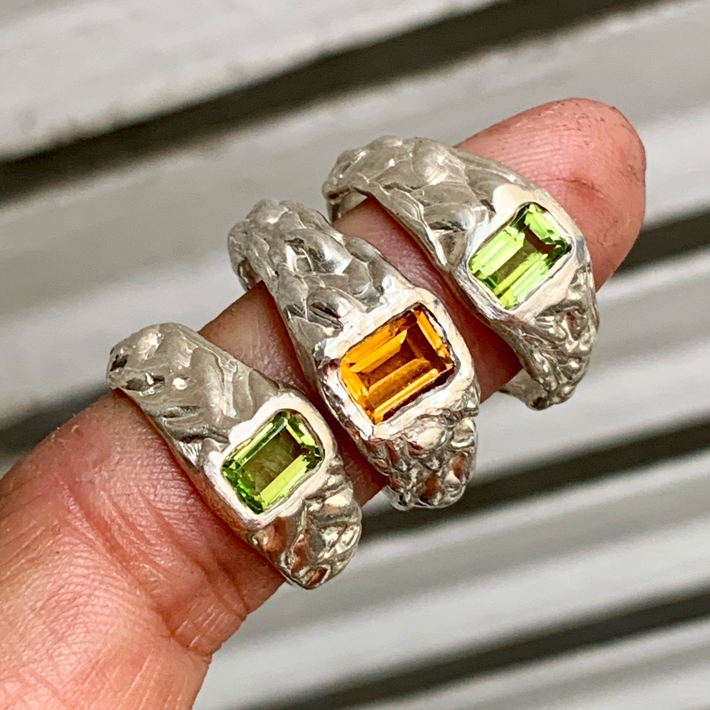 The Kuning Ring, inspired by the Indonesian word "Kuning" meaning yellow, is a chunky and casual sterling silver ring with a wavy band textured, featuring a bold and vibrant yellow citrine stone, adding a touch of colour to the overall look.