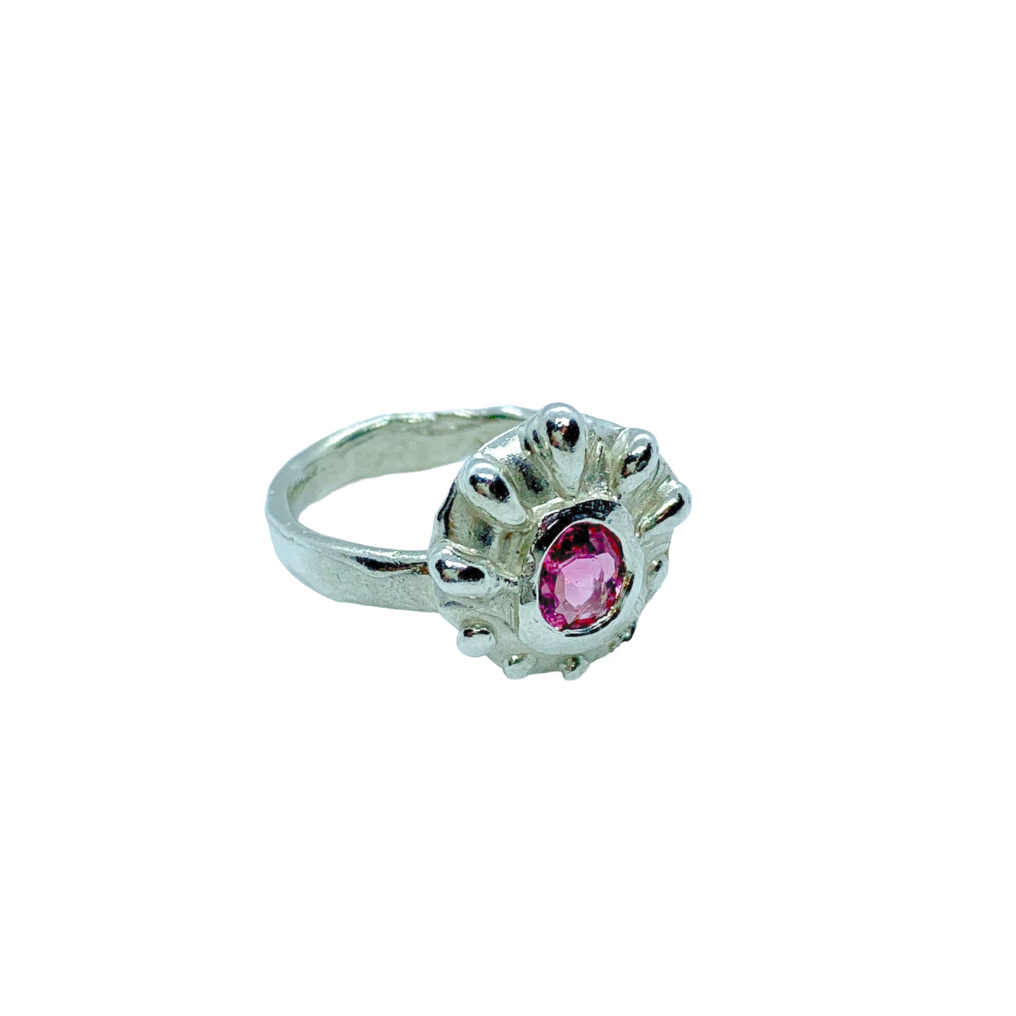 Introducing the Raffles Ring, a fun and casual silver ring that features a pretty pink tourmaline stone in the middle and a bumpy pattern around the stones that gives it a unique and playful look. It's perfect for everyday wear.
