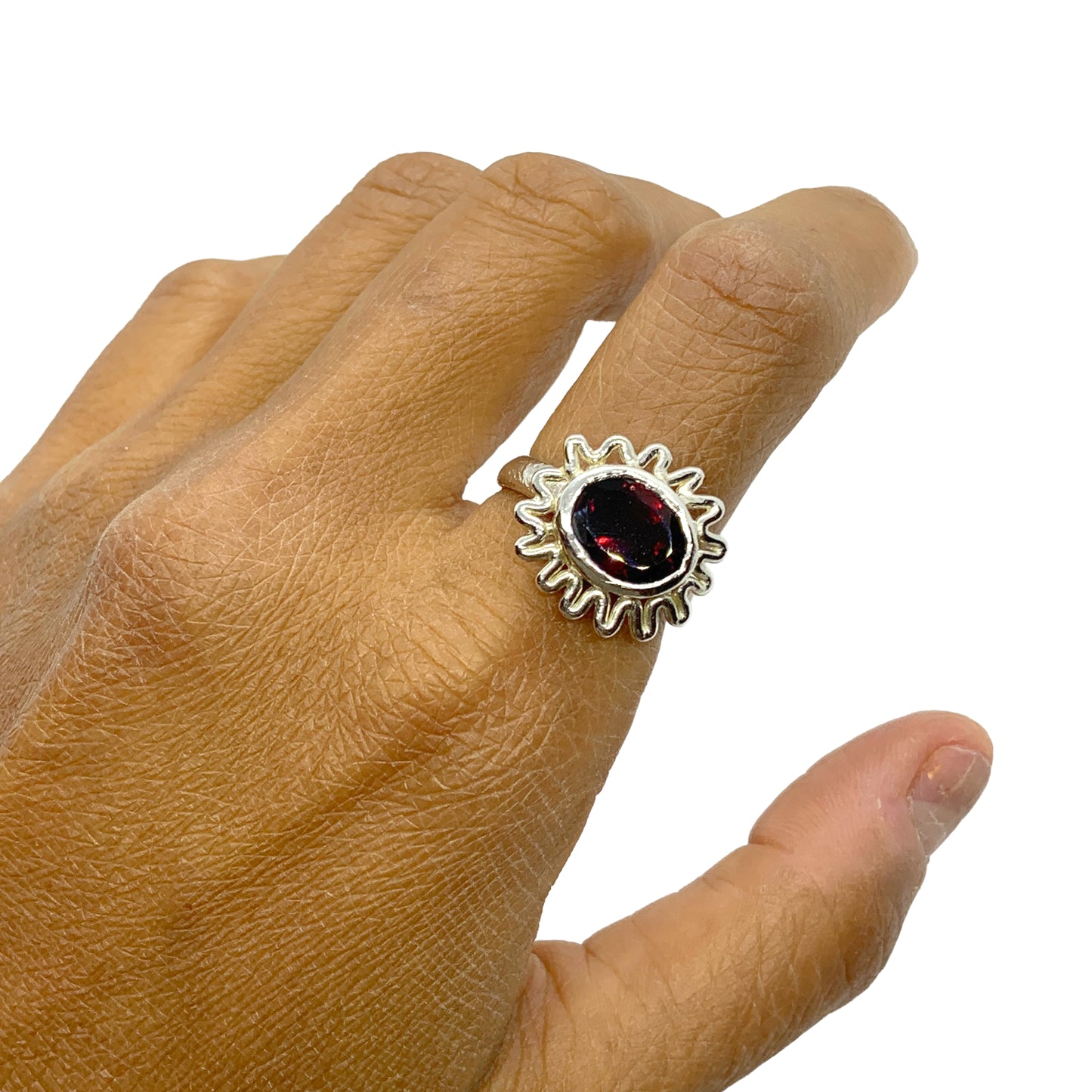 Sterling silver ring with red garnet and open-back design, fits sizes L–N. Shown in my finger with white background photo.