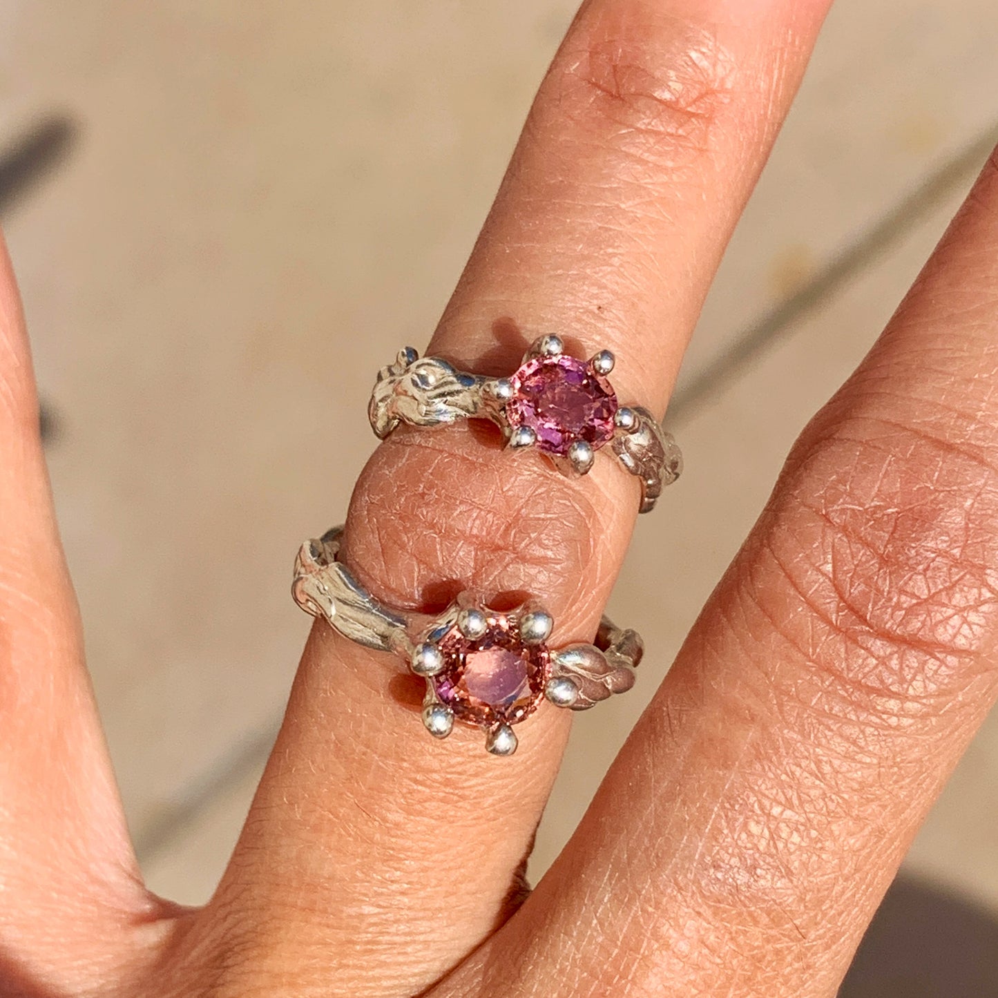 The Rosette ring coms with pink spinel stone. Made with sterling silver and held securely in place by six claws, this ring comes in a size K 1/2 or 5 3/8.