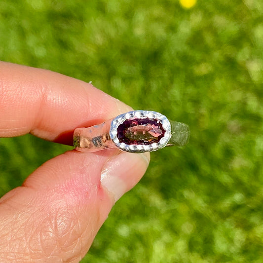 Double Harmony Rings come in a set of two. One ring features a pink tourmaline stone, and the other features three small pearl stones. Handmade from sterling silver, these stacking rings come in a single size: O ½ (or 7 ¼).