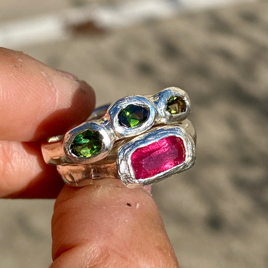 Handmade by Lia from Lia Makes Jewellery, this sterling silver ring stack features green and pink tourmalines. Sold as a set of two, available in size O 1/2 (US 7 1/4).
