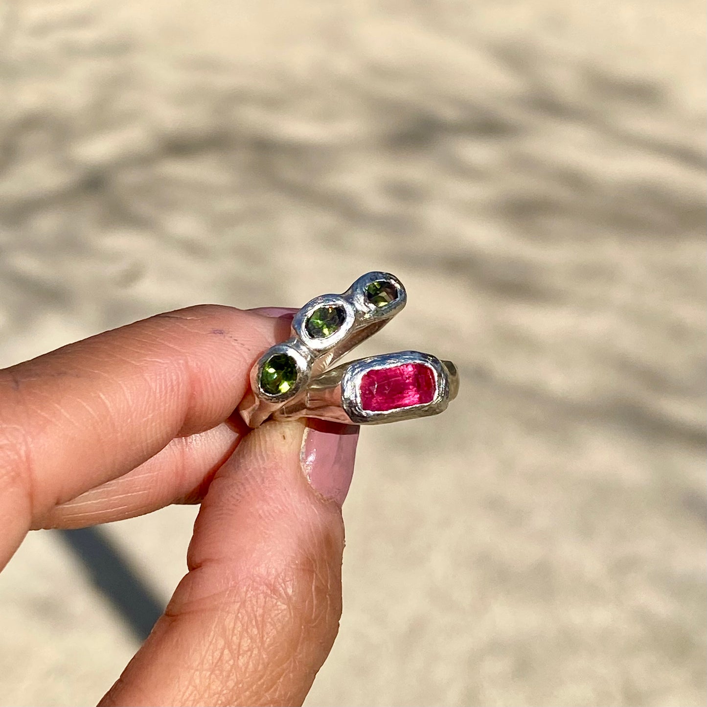 Handmade by Lia from Lia Makes Jewellery, this sterling silver ring stack features green and pink tourmalines. Sold as a set of two, available in size O 1/2 (US 7 1/4).
