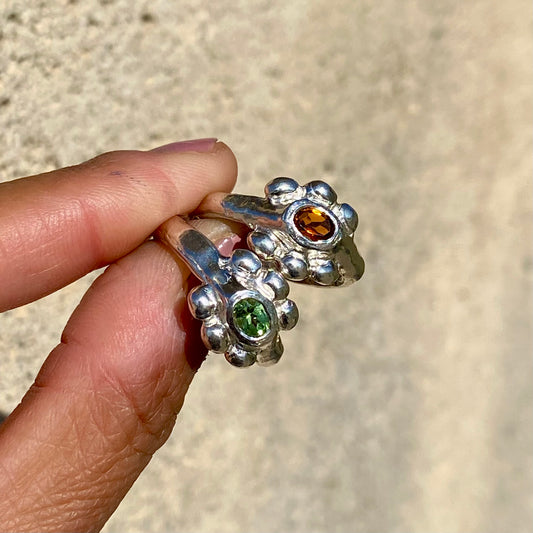 Fleur Ring — meaning flower in French — is a sterling silver ring featuring a vibrant tourmaline stone, available in green, pink, yellow, and light blue. This updated version of the Fleur Ring comes with a thicker band for a bolder look.