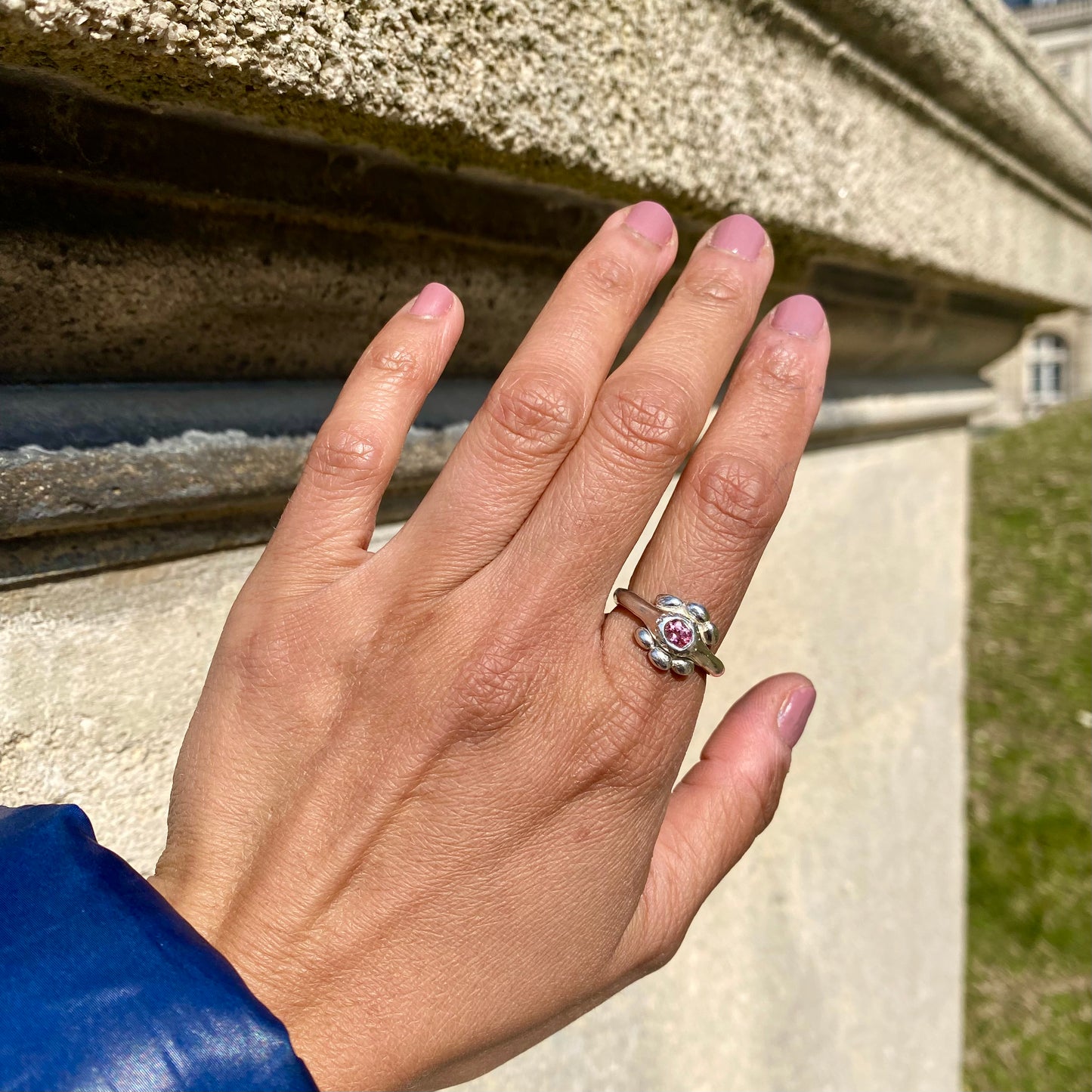 Fleur Ring — meaning flower in French — is a sterling silver ring featuring a vibrant tourmaline stone, available in green, pink, yellow, and light blue. This updated version of the Fleur Ring comes with a thicker band for a bolder look.