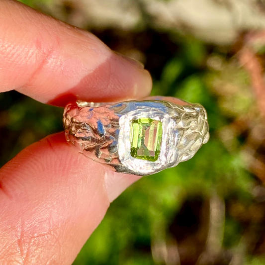 Handmade sterling silver Leafy Ring with textured wavy band and green peridot stone. Available in size L ½ (US 5 7/8).