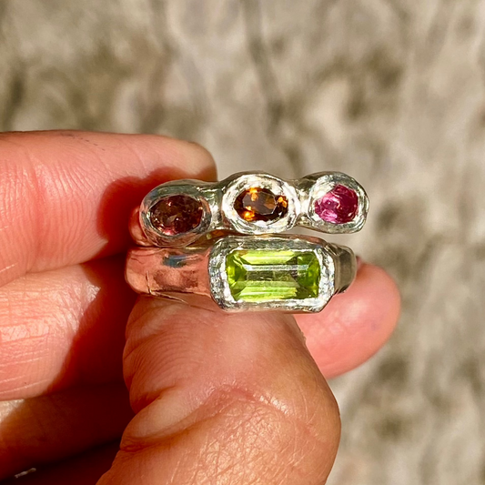 Green &amp; Blush Ring Stack comes as a set of two. One ring features three pink tourmaline stones, while the other holds a green peridot. Handmade by me in sterling silver, these stacking rings are available in size P (US 7 1/2).