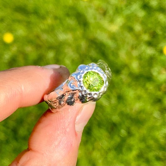 Embrace springtime with the Hallo Green Ring! This chunky sterling silver ring features a vibrant green peridot stone. Available in size O (US 7) with resizing services. Shop unique, handmade jewellery by Lia Makes Jewellery!