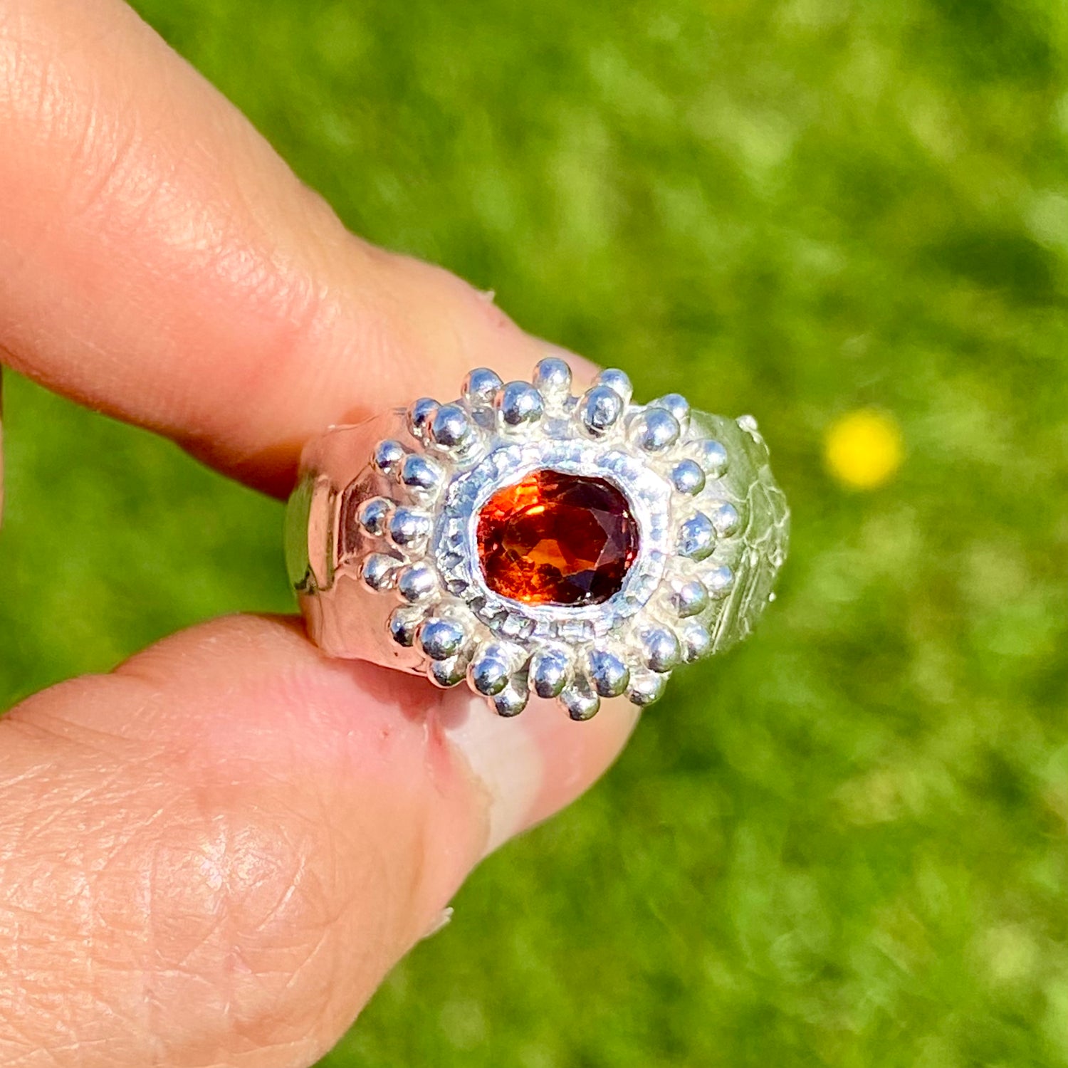 Orange Whisper Ring features an orange citrine in a wide chunky band. Handmade from sterling silver, this ring comes in a single size: M 1/2 or 6 1/4. 