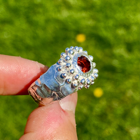 Orange Whisper Ring features an orange citrine in a wide chunky band. Handmade from sterling silver, this ring comes in a single size: M 1/2 or 6 1/4. 