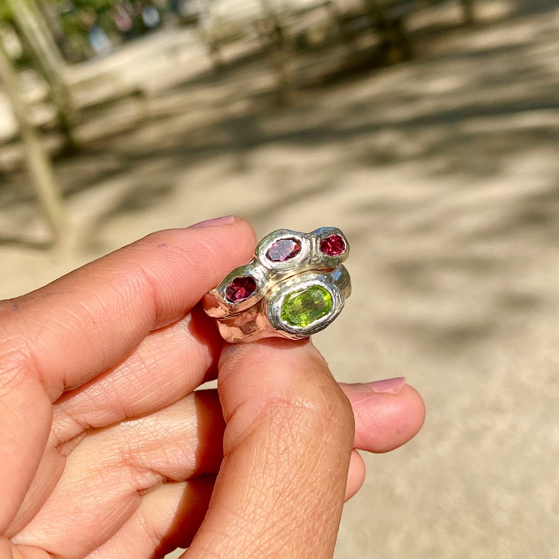 Pink Oasis Ring Stack comes as a set of two stacking rings. One ring features three pink tourmaline stones, while the other holds a green peridot. Handmade by me in sterling silver, these rings are available in size P (US 7 1/2).