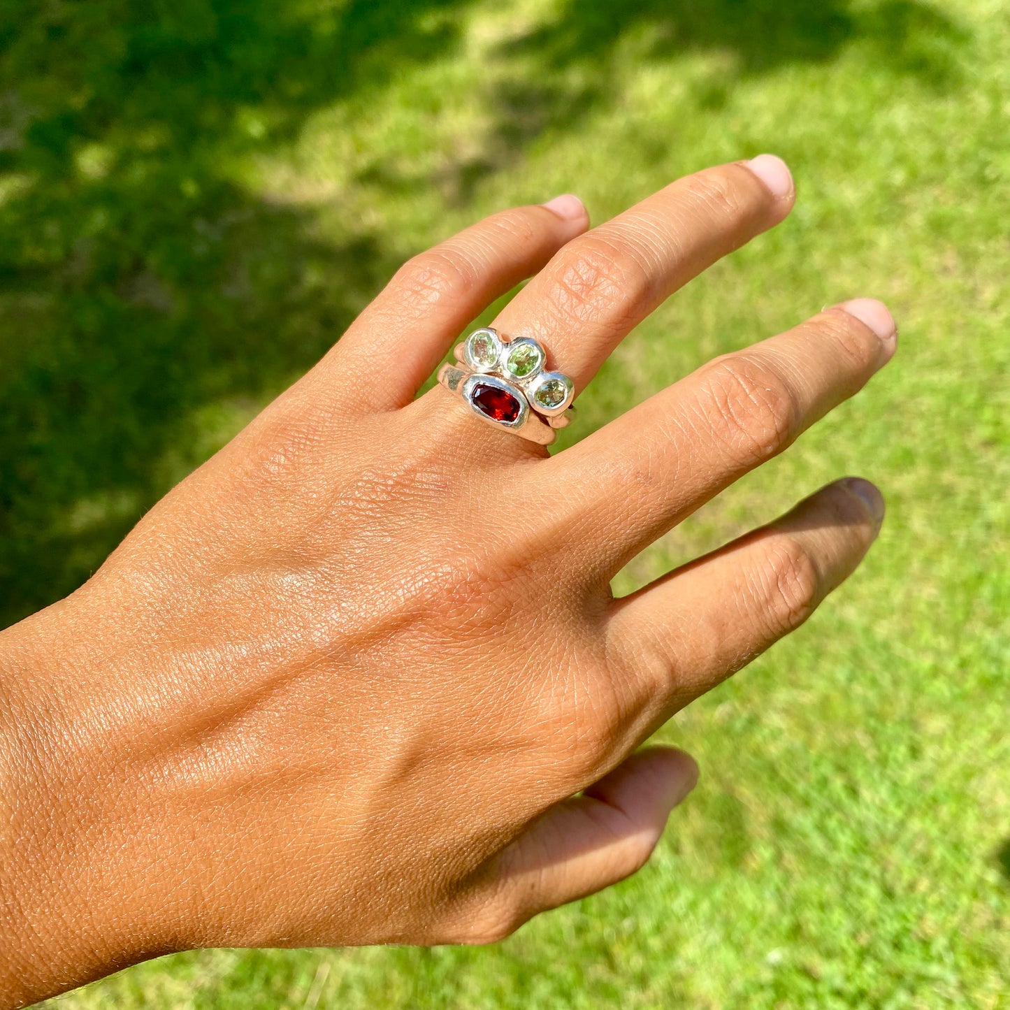 The Red Forest ring stack comes as a set of two. One ring features three light green bluish tourmaline stones, and the other has a long red oval garnet stone. Handmade by me from sterling silver, these stacking rings are available in one size:&nbsp;O ½ (US 7 ¼)