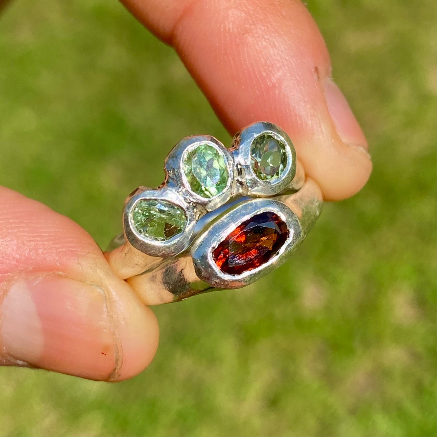 The Red Forest ring stack comes as a set of two. One ring features three light green bluish tourmaline stones, and the other has a long red oval garnet stone. Handmade by me from sterling silver, these stacking rings are available in one size:&nbsp;O ½ (US 7 ¼)