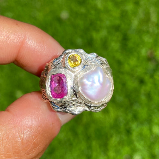 Spring Petals features a thick band with three stones: Keshi pearl, pink topaz, and yellow sapphire. The ring is available in size N 1/2 (US 6 3/4).