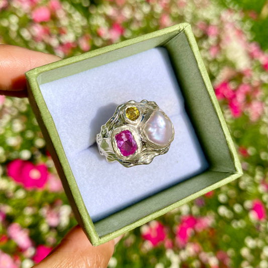Spring Petals features a thick band with three stones: Keshi pearl, pink topaz, and yellow sapphire. The ring is available in size N 1/2 (US 6 3/4).