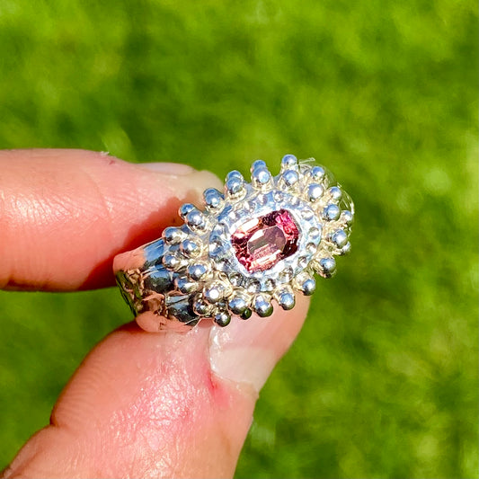 Embrace springtime with the Whisper Bloom Ring! This chunky sterling silver ring features a delicate pink spinel gemstone. Available in size US 6 ¼ (with resizing services). 