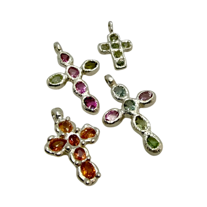 Group of handmade Harmony Cross pendants in sterling silver with pink and green tourmalines, crafted by Lia Makes Jewellery in Paris.