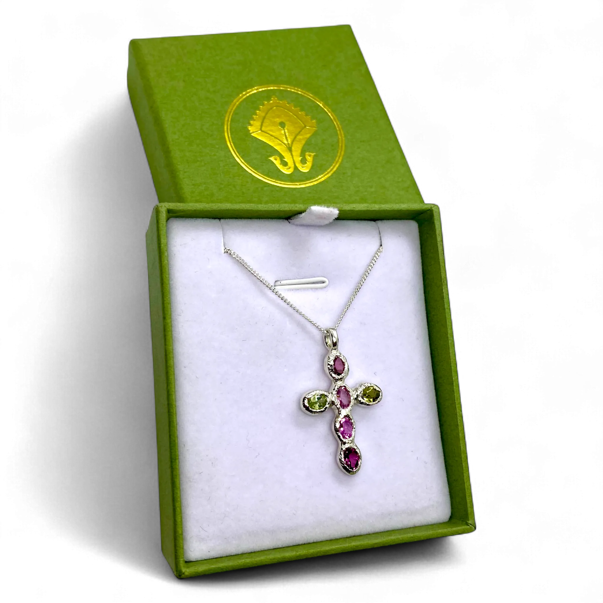 Harmony Pink Cross pendant presented in its jewellery box, showing sterling silver and vibrant tourmaline gemstones.
